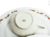 a plate with a cup and saucer on top of it