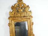 a mirror on the wall with a gold frame
