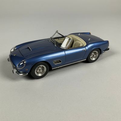 a close up of a blue toy car on a white surface