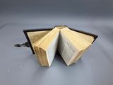 two open books sitting on a table with one open