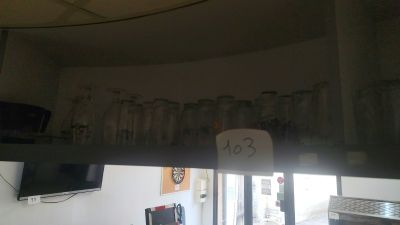 a picture of a kitchen with a lot of glasses hanging from the ceiling