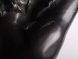 a close up of a statue of a man with his hands on his chest