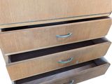 a wooden dresser with three drawers in it