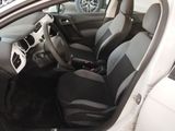 the interior of a small car with black seats and a steering wheel