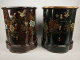 pair of black and gold decorated vases sitting on top of each other