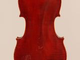 an antique violin with a wooden back and a red body