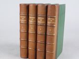 three books sitting on top of each other on a white surface