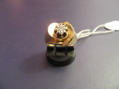 a gold ring with a lion on it on a purple surface