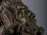 bronze bust of a bearded man with a beard and long hair