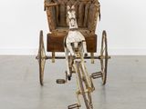 a horse and buggy that is sitting on the floor