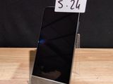 a cell phone that is sitting on a wooden table