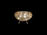 a silver bowl that is sitting on a black surface
