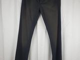 a pair of black jeans hanging on a white curtain
