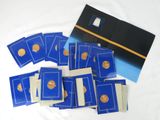 a pile of blue and gold coins on a white surface