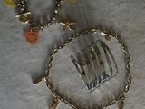 a necklace with a fork and a bracelet with charms on it