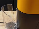 a blender sitting on a wooden table next to a glass