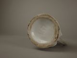 a close up of a white cup on a table
