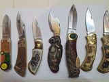 several different types of knives are lined up on a white board