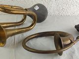 two brass trumpets sitting next to each other on a table