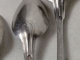 three spoons and two spoon spoons on a table