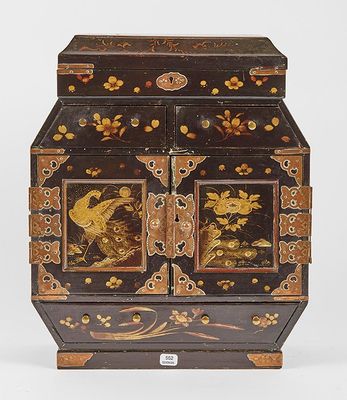 a black and gold box with birds and flowers on it