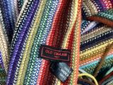 a close up of a pile of multicolored yarn with a tag on it