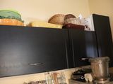 a kitchen with black cabinets and a blender on the counter