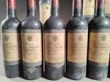 several bottles of wine are lined up on a table