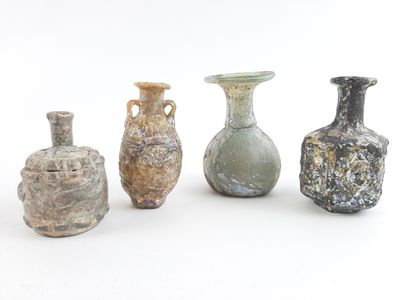 several different colored vases are lined up on a white surface
