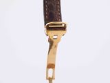 an image of a gold watch with a brown leather strap