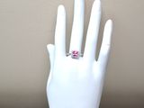 a white mannequin hand with a pink ring on it