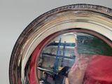 a reflection of a person taking a picture in a mirror