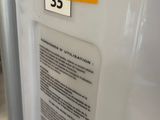 a white refrigerator with a yellow sticker on it