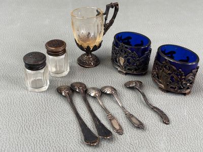a lot of spoons, salt and a glass on the table