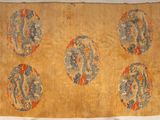an old chinese rug with four dragon designs on it