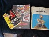 three books that are sitting on a black cloth