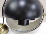 a black lamp that is sitting on a white table