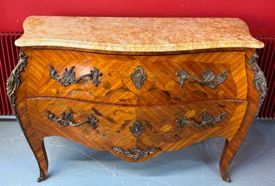 a wooden chest of drawers with a marble top