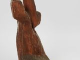 a figurine of a bird that is sitting on a branch