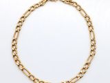 a gold chain bracelet with a link on a white background