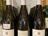 several bottles of wine are lined up on a counter