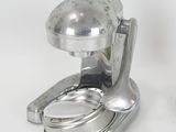 a silver object that is sitting on a white surface