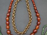 a group of necklaces, bracelets, and earrings on a table