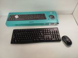 a computer keyboard and a mouse on a table
