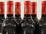 several bottles of wine are lined up on a table
