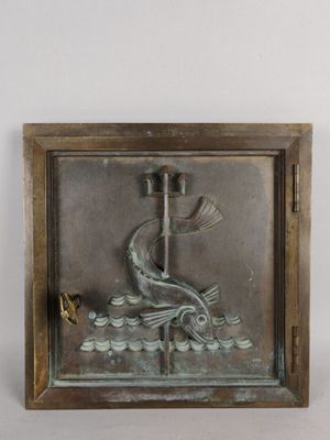 bronze plaque of a fish on a boat with a bird in the water