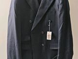 a suit hanging on a hanger on a wall