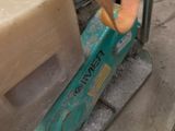 someone is using a machine to cut a piece of wood