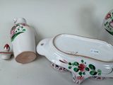three pieces of pottery sitting on a white table