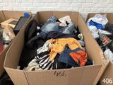 a cardboard box filled with clothes and other items